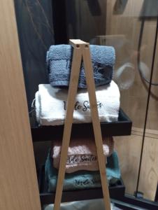 a stack of towels on a shelf in a room at Уютно Студио Verde Suites 07 in Blagoevgrad