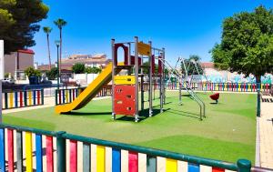 a playground with a slide in a park at Cactus Apartment La Ribera in Santiago de la Ribera