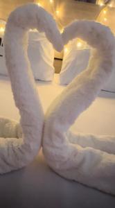 a heart made out of white towels on a bed at Couple's Getaway in Is-Swieqi