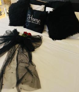 a bed with a dress and a bag on it at Couple's Getaway in Is-Swieqi