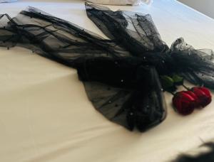 a black umbrella on top of a cake at Couple's Getaway in Is-Swieqi