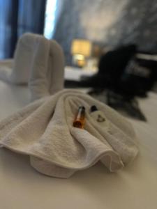 a white towel with a bottle in it on a table at Couple's Getaway in Is-Swieqi +37 photos