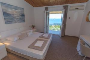 a bedroom with a bed with a view of the ocean at Apartmani Ana in Mlini +48 photos