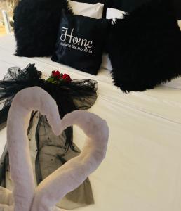 a bed with two towel flamingos and a pillow on it at Couple's Getaway in Is-Swieqi