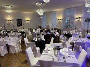 a banquet room with white tables and white chairs at Hof Podis Pootsi veinimõis in Pootsi