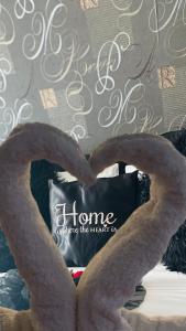 a heart shaped pillow with the words home since the heart is at Couple's Getaway in Is-Swieqi