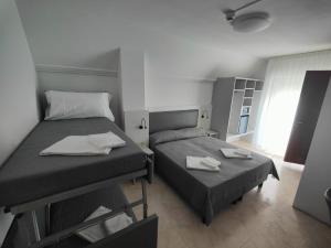Postel nebo postele na pokoji v ubytování Hotel DOLCEVITA Park & Beach included