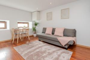a living room with a couch and a table at Gardenia Urban Retreat in Porto +8 photos