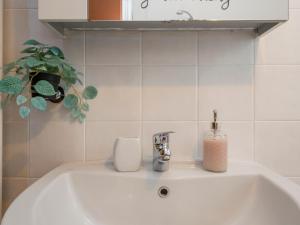 a white sink in a bathroom with a plant at Spazio Breda - Free Parking, Private Garage, Metro M1, Balcony, 4 Guests in Milan +51 photos