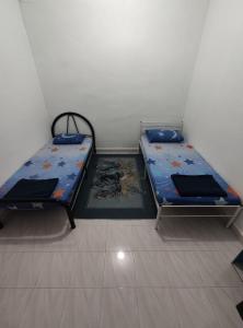 Postel nebo postele na pokoji v ubytování Seri Homestay