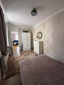 a bedroom with a bed and a dresser with a mirror at Nikolai 9-3 in Pärnu