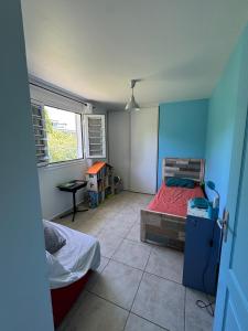 a small bedroom with a bed and a window at Villa Morne-Bou in Petit-Bourg +24 photos
