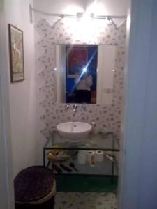 a bathroom with a sink and a mirror at Torretta 16 red room in Tuscania
