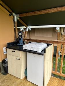 a kitchen with a stove top on a counter at Romala's Mini Glamp in Kiel