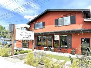a red building with a sign that reads fox and firm coffee at Bluebird Day - Fox Den South in Bend