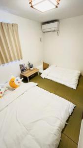 Voodi või voodid majutusasutuse 柚子屋 新築貸切戸建旅館 toas +60 fotot