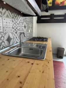 a kitchen with a sink and a wooden counter top at Villa Amaryllis in Pulsano
