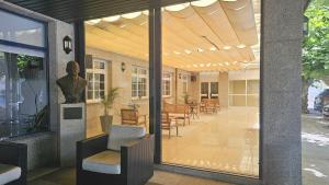 a room with glass doors and a table and chairs at Hotel Miramar Playa America Nigran in Nigrán