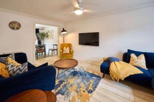 a living room with blue couches and a table at Host & Stay - Blueberry House in Launceston