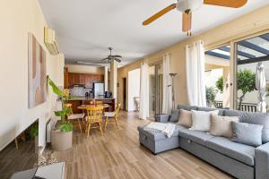 a living room with a couch and a table at Seaview Villa in Peyia with Private pool by VICHY Holidays in Paphos +28 photos