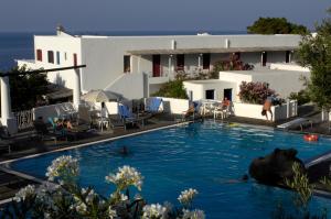 a swimming pool with a bear in the water at La Sirenetta Park Hotel in Stromboli