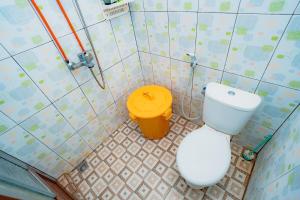 a bathroom with a toilet and a trash can at Guesthouse Andalusia Gontor 1 Ponorogo in Ponorogo +3 photos