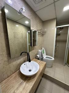 a bathroom with a sink and a toilet at Bukit Bintang KLCC Fairlane suite by Rose in Kuala Lumpur