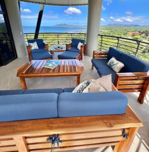 a living room with couches and a table at La Perla 161-Oceanview,Penthouse,Walking Distance in Tamarindo