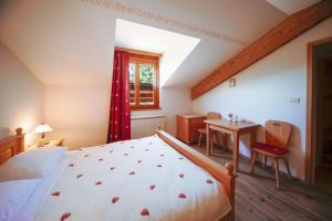 a bedroom with a bed and a table and a window at Green Escape garni hotel in Postojna +19 photos