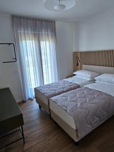 Postel nebo postele na pokoji v ubytování Appartamenti Mare Azzurro + 31 fotografií