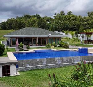 a house with a swimming pool in the yard at Villa MountainView Guesthouse in Dimiao