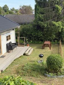 a backyard with a grill and a wooden deck at Sportfiskestugan in Färjestaden