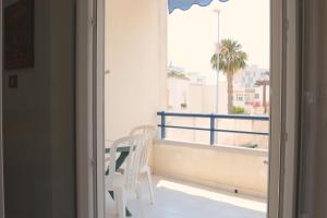 a balcony with a table and chairs and a window at AP Apartment - Baia Verde in Baia Verde
