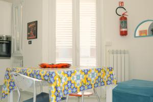 a table with a table cloth on it in a kitchen at AP Apartment - Baia Verde in Baia Verde