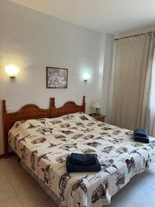 a bedroom with a bed with a quilt on it at Los Angeles in Los Cristianos