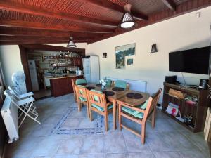 a dining room with a wooden table and chairs at Casa Elena in Eforie Sud