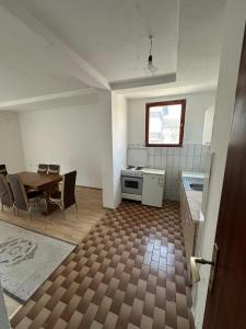 a kitchen and dining room with a table and chairs at Lea Apartment in Struga