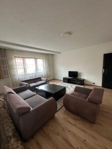 a living room with two couches and a television at Lea Apartment in Struga