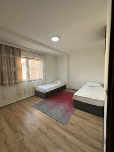 a bedroom with two beds and a window at Lea Apartment in Struga