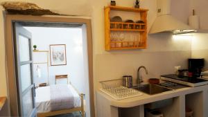a kitchen with a sink and a counter top at Lagadi House 1 in Arnados +27 photos