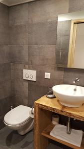 a bathroom with a sink and a toilet at Hotel Du Clocher in Chamonix-Mont-Blanc +58 photos
