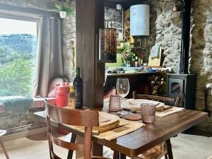 a wooden table with chairs and a table with wine glasses at cabaña do rei in Betán +44 photos