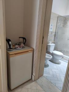 a bathroom with a toilet and a sink at B&B Betania in Riposto