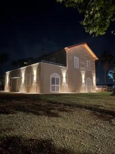 a house with lights on the side of it at night at Serenity House Latina in Latina