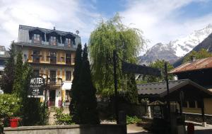 a building with a street sign in front of it at Hotel Du Clocher in Chamonix