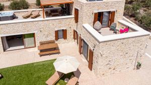 an overhead view of a house with an umbrella at Sun and Sea Cretan Hospitality in Pitsidia