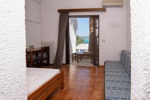 a room with a bed and a table with a view at Delfini Apartments in Kissamos