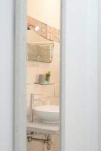 a bathroom with a white sink in a room at AP Apartment - in centro! in Gallipoli +37 photos