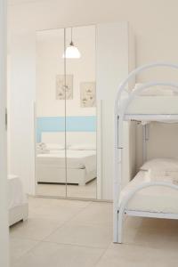 a bedroom with a bunk bed and a mirror at AP Apartment - in centro! in Gallipoli