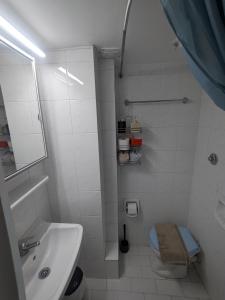 a white bathroom with a sink and a toilet at Herakleion center single room in Bendevís +14 photos